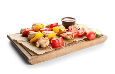 Wooden board of grilled chicken skewers with vegetables and sauce isolated on white background