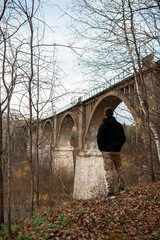 man look at the old stone bridge