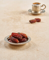 Ramadan date in the zinc plate turkish culture style with rosary and coffee.