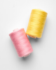 Different thread spools on white background