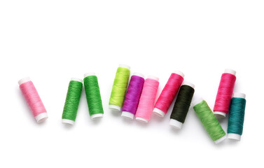 Different thread spools on white background