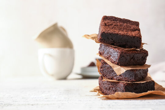 Pieces of delicious chocolate brownie on table