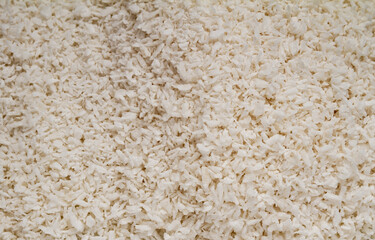 Coconut shreds background texture. Raw organic flakes backdrop.