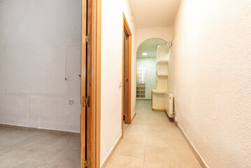 Corridor of a residential building with ceramic stoneware floors and plaster furniture and pine carpentry