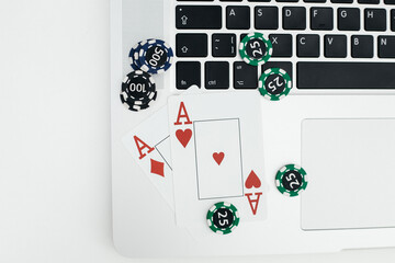Playing cards on laptop keyboard. Online casino concept. Top view