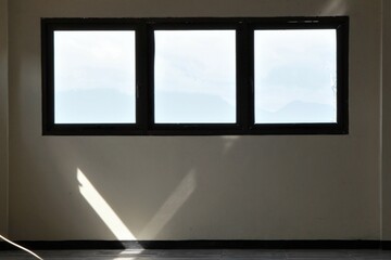 Window light in a white room with symmetrical windows, Bandung, Indonesia, February 27, 2022