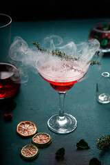 Glass of red drink on the table with backlight