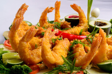 Eastern food. Fried crispy shrimp with vegetables on white background.