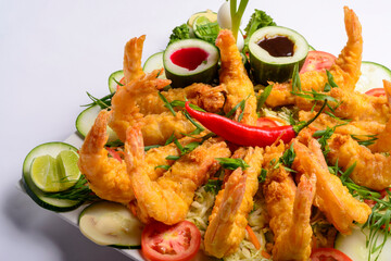 Eastern food. Fried crispy shrimp with vegetables on white background.