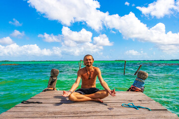 Tourist traveler meditate Muyil Lagoon panorama view turquoise water Mexico.