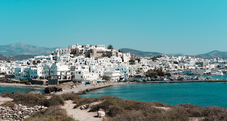 Fototapeta premium Chora town in Naxos Island view from portara inlet, white greek architecture, sea scape, town scape