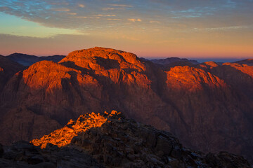 Sunrise on the summit of the Holy Mount Moses (Mount Sinai, Mount Horeb or Gabal Musa), Egypt, North Africa. Low exposure	