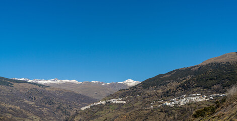 Fototapeta na wymiar panorama view of the idyllic whitewashed Andalusian mountain village of Capileira in the Sierra Nevada