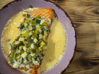 fried trout in a plate. Red fried fish in sauce.