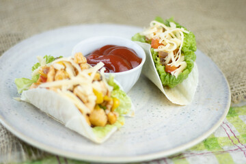 Tacos with lettuce, cheese and tomato