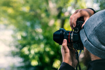 Fototapeta premium Photographer taking pictures in the woods outdoor forest nature. Course Lesson class learning photography 