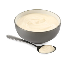 Ceramic bowl and spoon with mayonnaise on white background
