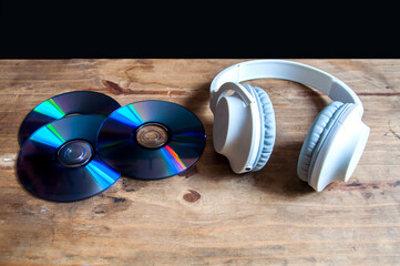 headphones and dvds on a wooden background