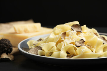 Tasty tagliatelle with truffle on table, closeup
