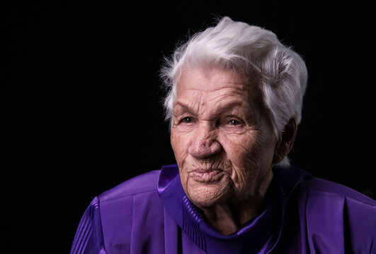 Portrait Of Serious Senior Woman Against Black Background