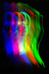 Abstract woman silhouette portrait in bright light trails of light painting in RGB split style of...