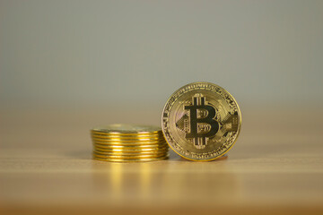 Gold colored bitcoin coins arrangement stacks of coins on wooden background. Cryptocurrency concept. Business,  Economy, Investment and finance concept. Bitcoin Concept.