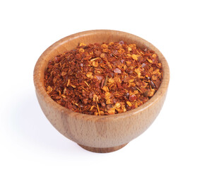 dried chili peppers in a wooden cup on a white background