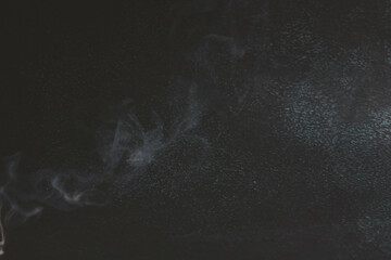 incense and smoke on black background