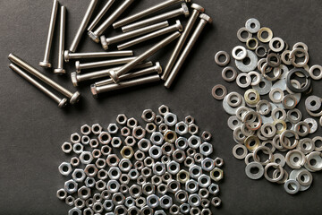 Metal nuts and bolts close up on black background