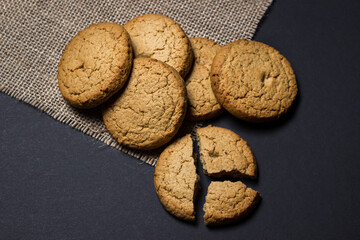 Oatmeal cookies on a black background. Light and tasty dessert. Healthy breakfast