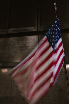 Waving American flag on dark street