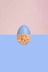 Modern minimal concept made with purple Easter egg and pastel pink flower. Modern spring aesthetic.