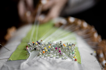 Unrecognizable embroiderer making bobbin lace