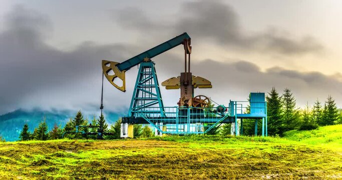 Rapid movement of clouds over a classic oil gas pump in the carpathians Ukraine in time-lapse technique vide. An ancient hydrocarbon deposit in Europe, more than a hundred years old.