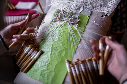 Unrecognizable embroiderer making bobbin lace