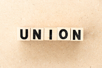 Alphabet letter block in word union on wood background