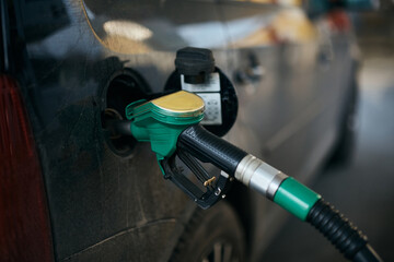 Close-up of filling gas into car gas tank.
