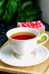 Close up pouring hot black tea in a white tea cup , Tea ceremony time concept