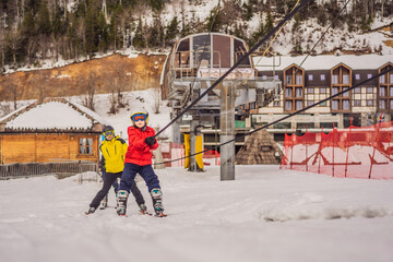 Instructor teaches boy skier to use on ski lift