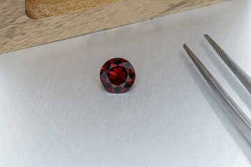 macro mineral faceted stone cut Garnet on a gray background