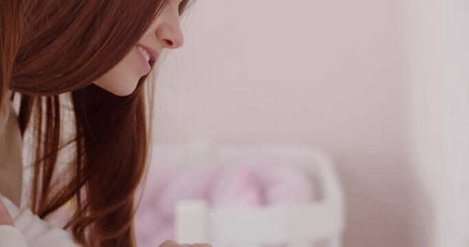 Mom gently caresses her newborn baby