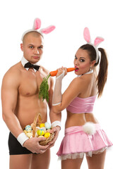 Lovely couple in r      фabbit costumes with carrots and eggs