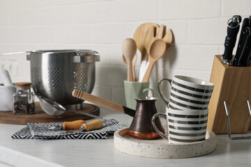 Different cooking utensils on countertop in kitchen