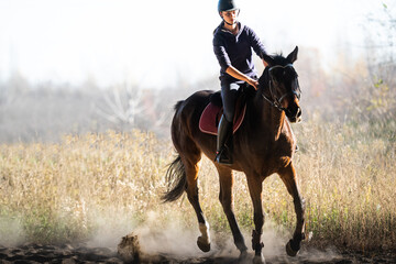 Young girl riding a horse