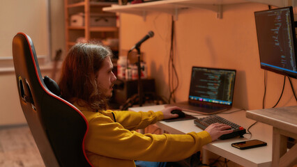 Male IT developer watch on monitor while program