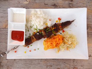 Horse meat shish kebab (skewers) plate on a restaurant in Mongolia.  