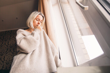 Sad pensive adult 40s woman at home