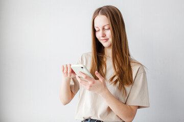 teen girl looking at screen of phone