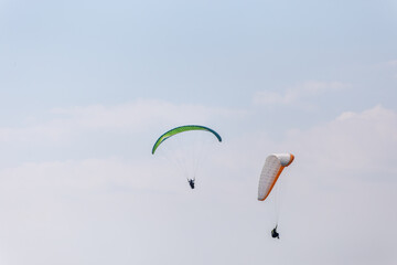 Paraplaners with beautiful blue sky and clounds in the background