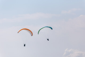 Paraplaners with beautiful blue sky and clounds in the background